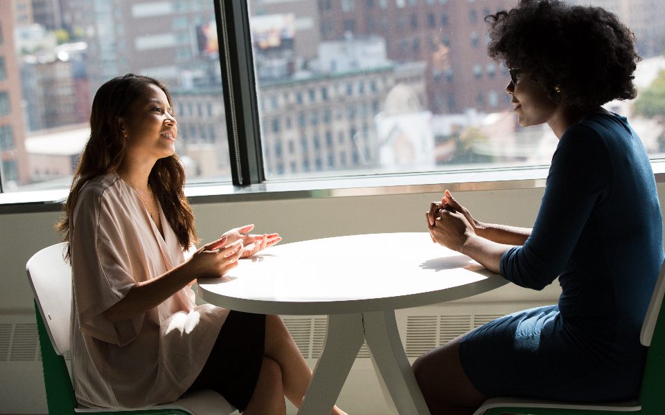 Two colleagues talking through a technology decision