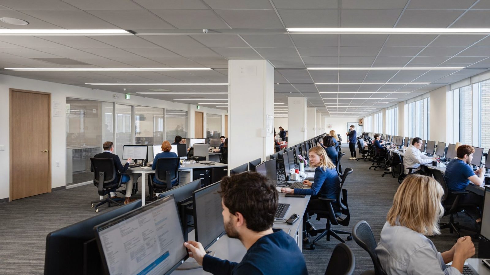 Open-plan operations floor with teams working at shared desks