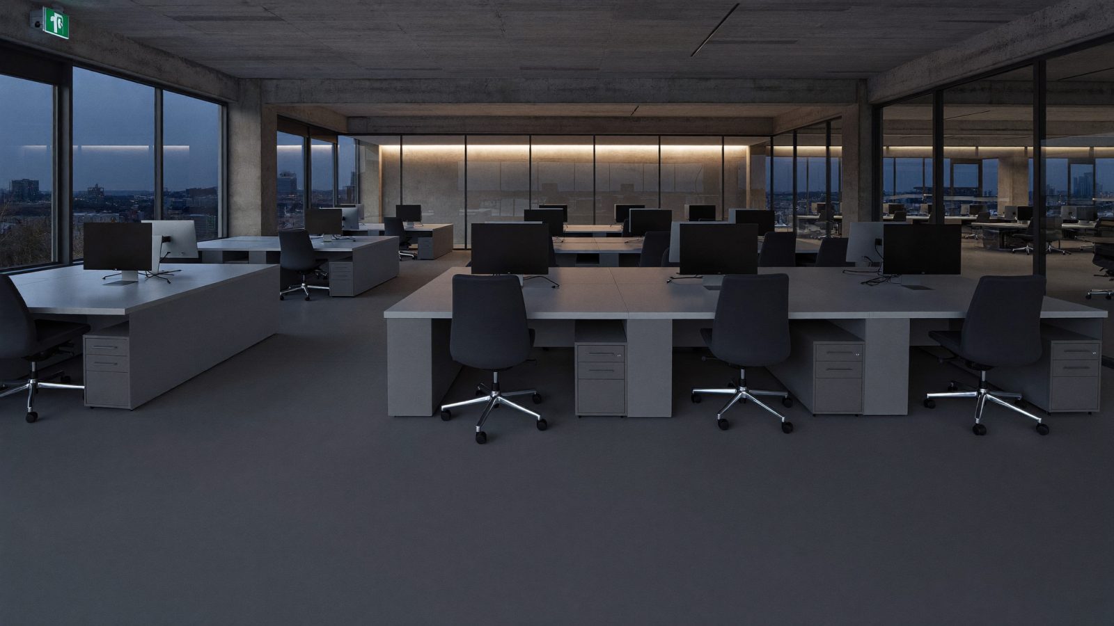 Quiet engineering floor at dusk with workstations powered down