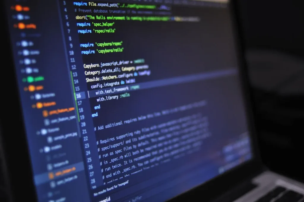 Engineers reviewing connected systems together on laptops