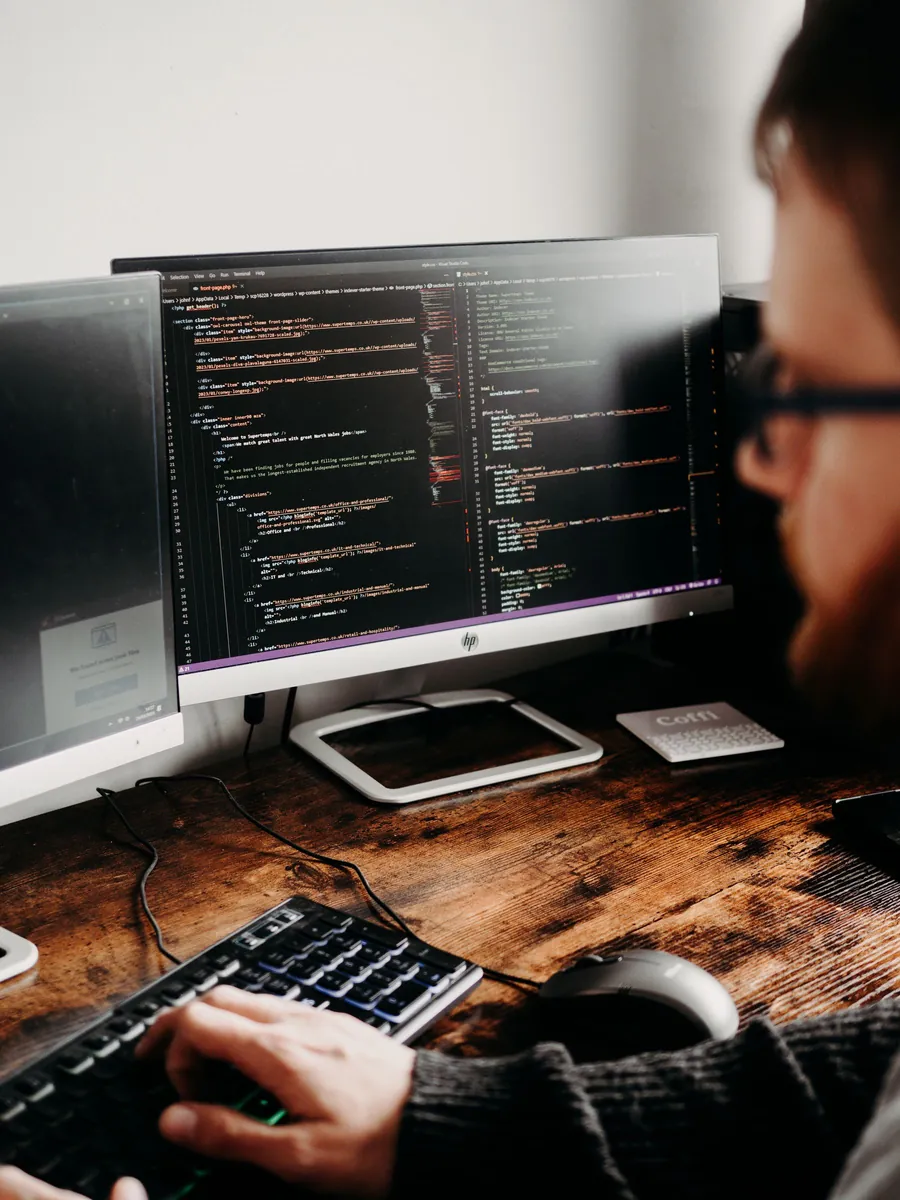 Developer writing application code on a laptop