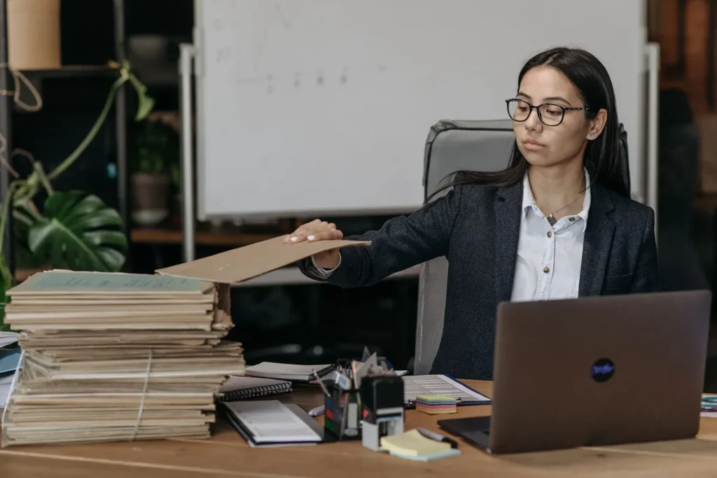 Professional team reviewing a project around a laptop