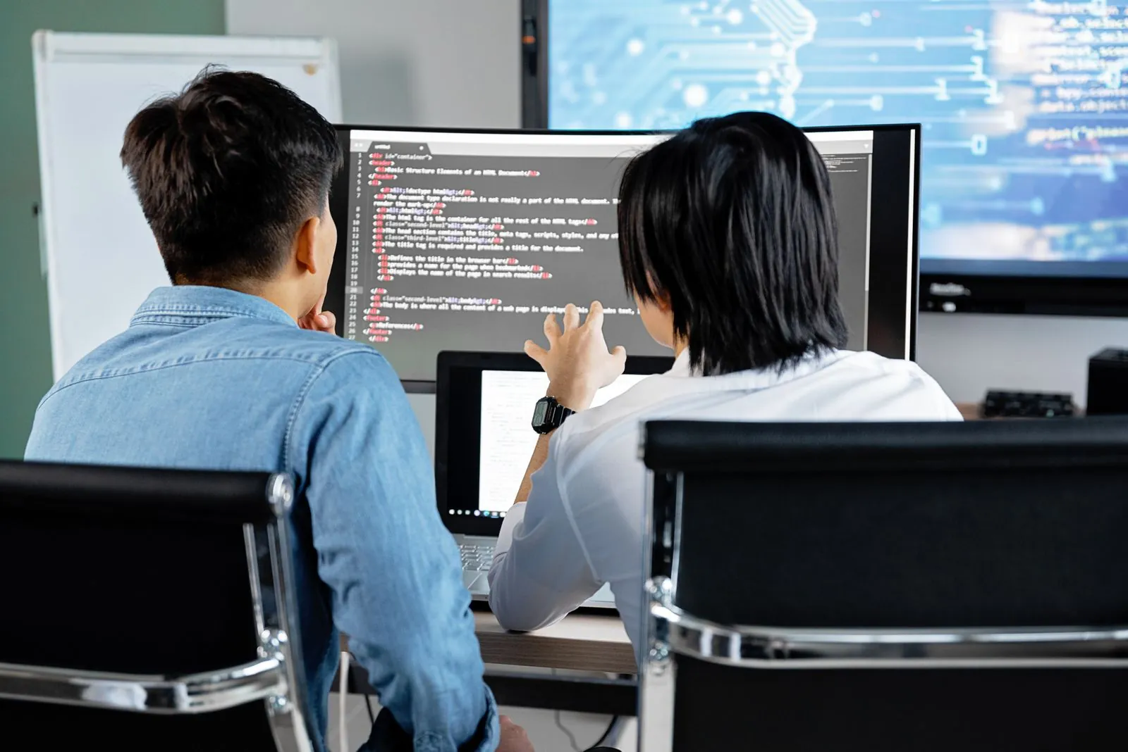 Engineering team reviewing code together in a meeting room
