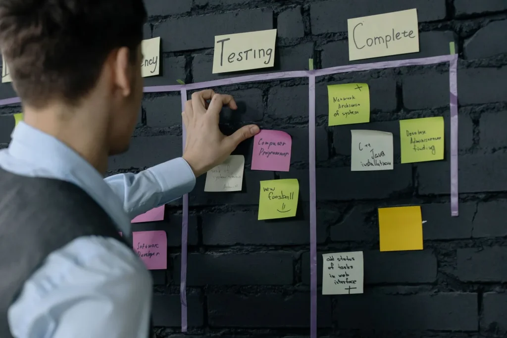 Product team mapping a build across notes on a table
